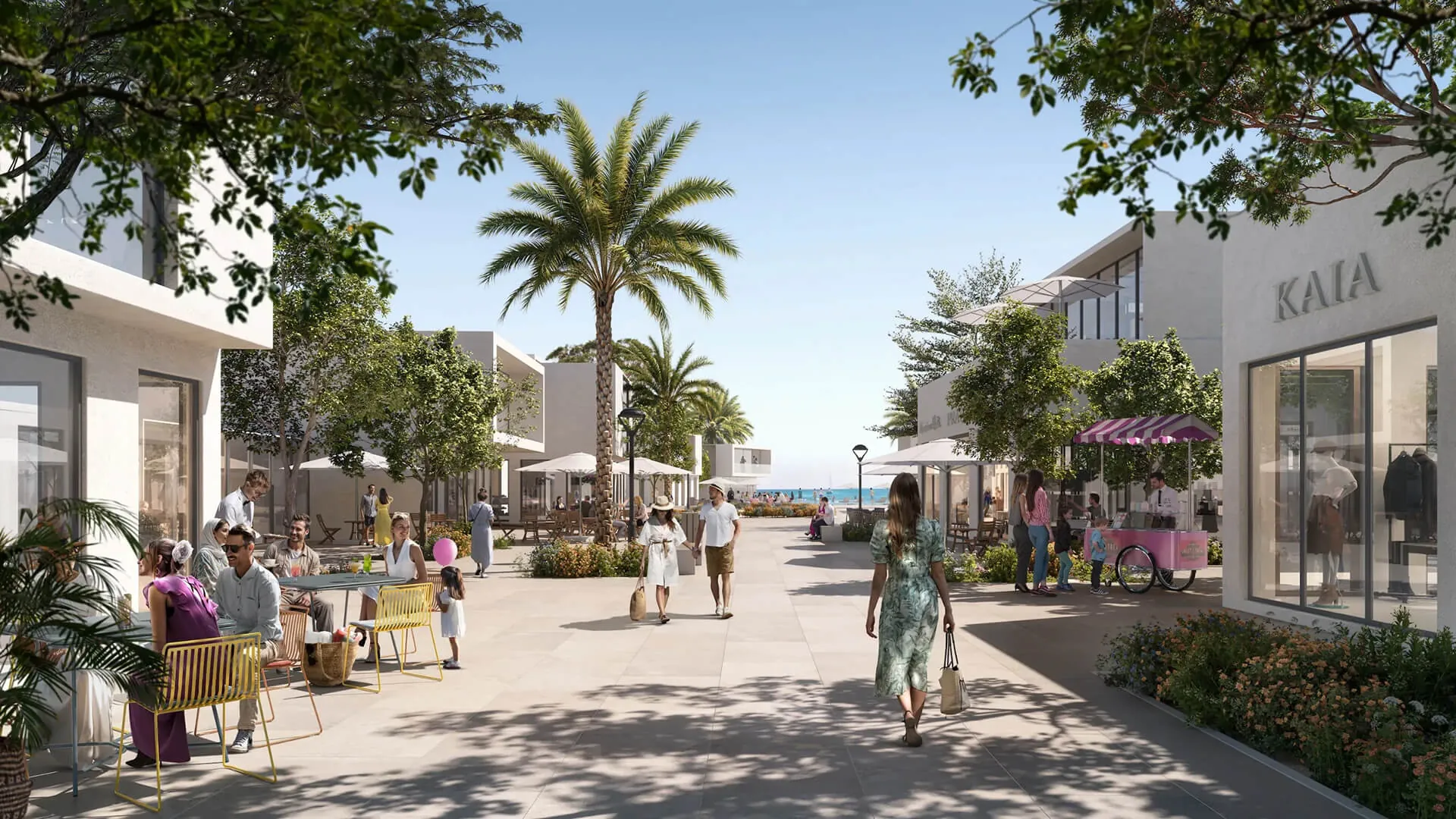 Tree-lined beach town promenade with cafés and boutiques at Bayn by ORA